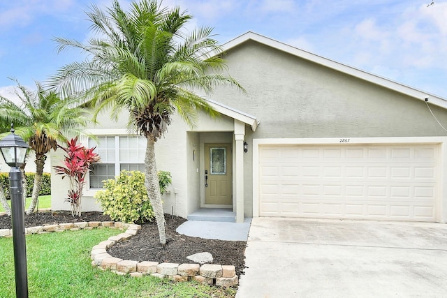 2867 SW Mustang Ter, Stuart, FL 34997 - view of front of home featuring stucco siding, a garage, and concrete driveway