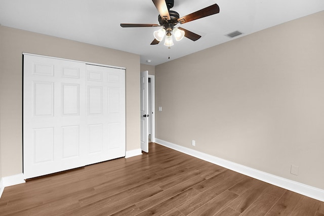 2867 SW Mustang Ter, Stuart, FL 34997 - unfurnished bedroom featuring wood finished floors, baseboards, a closet, and a ceiling fan