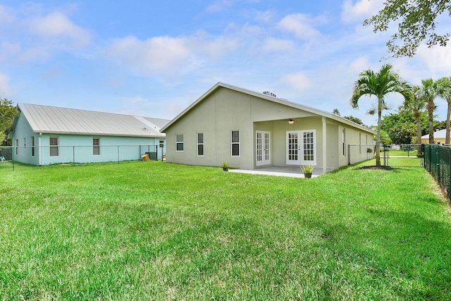 2867 SW Mustang Ter, Stuart, FL 34997 - back of property featuring french doors, stucco siding, a ceiling fan, and a patio
