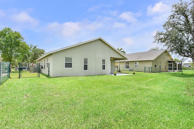 2867 SW Mustang Ter, Stuart, FL 34997 - rear view of property featuring a gate, a fenced backyard, stucco siding, and a patio