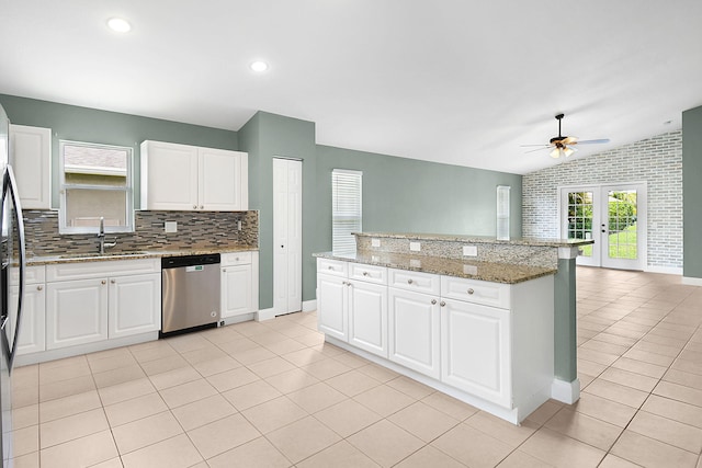 2867 SW Mustang Ter, Stuart, FL 34997 - kitchen featuring stainless steel dishwasher, a sink, light tile patterned floors, ceiling fan, and lofted ceiling