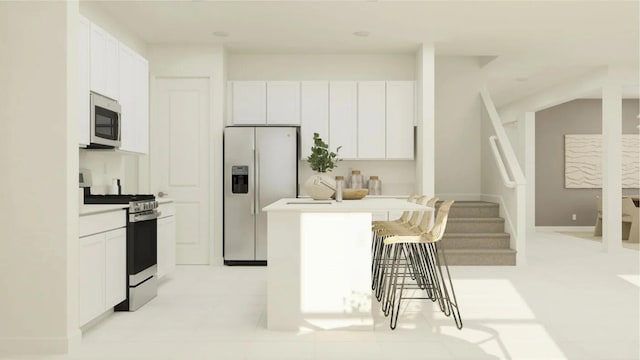 19153 Wood Stork Way, Loxahatchee, FL 33470 - kitchen featuring appliances with stainless steel finishes, a kitchen breakfast bar, white cabinets, a center island, and light countertops