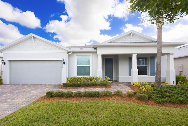 10299 SW Captiva Dr, Port Saint Lucie, FL 34987 - view of front facade featuring stucco siding, a garage, decorative driveway, a front yard, and a porch