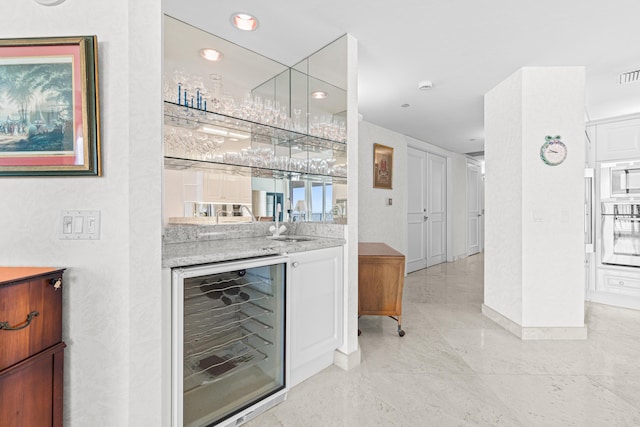 800 Ocean Dr Unit 204, Juno Beach, FL 33408 - indoor wet bar with beverage cooler, oven, white microwave, baseboards, and recessed lighting
