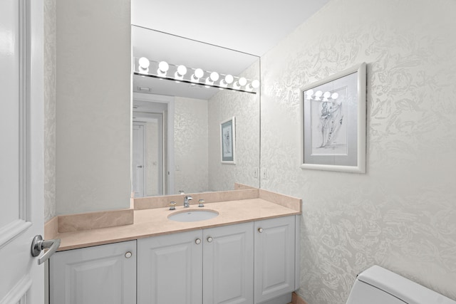 800 Ocean Dr Unit 204, Juno Beach, FL 33408 - half bath featuring wallpapered walls, toilet, and vanity