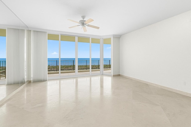 800 Ocean Dr Unit 204, Juno Beach, FL 33408 - unfurnished room featuring expansive windows, a ceiling fan, and a water view
