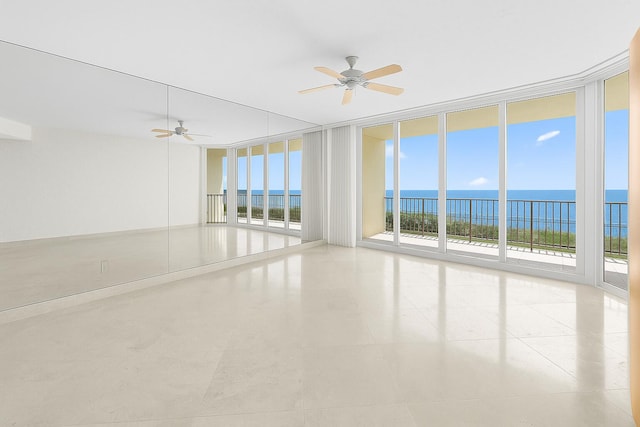 800 Ocean Dr Unit 204, Juno Beach, FL 33408 - tiled spare room featuring a wall of windows, ceiling fan, and a water view