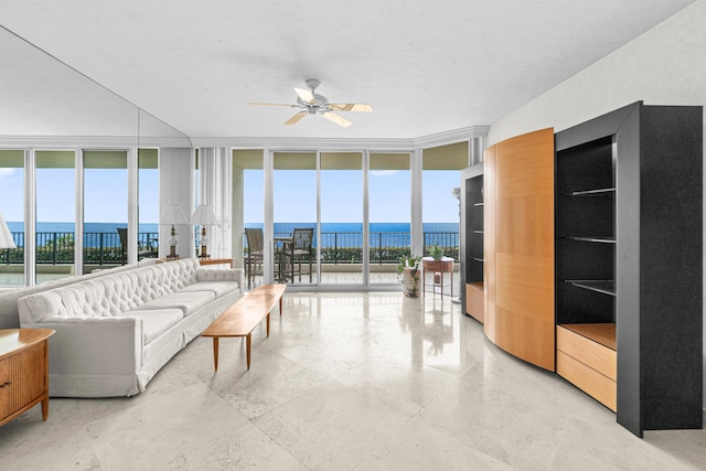 800 Ocean Dr Unit 204, Juno Beach, FL 33408 - living area with floor to ceiling windows, a ceiling fan, a water view, and healthy amount of natural light