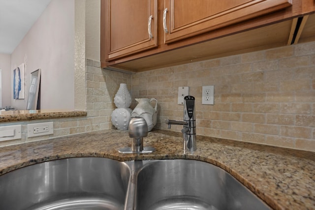 474 Francesca Ridge Rd, Boynton Beach, FL 33435 - kitchen view of decorative backsplash, brown cabinetry, and light stone countertops