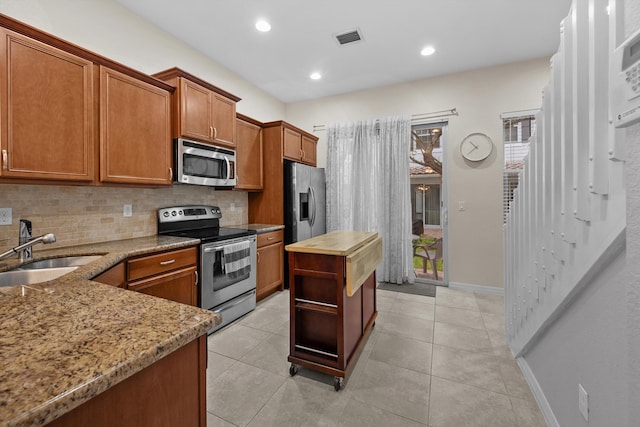 474 Francesca Ridge Rd, Boynton Beach, FL 33435 - kitchen with appliances with stainless steel finishes, a sink, decorative backsplash, light stone countertops, and recessed lighting