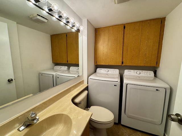 6006 60th Way, West Palm Beach, FL 33409 - bathroom with washer and dryer, toilet, vanity, and tile patterned floors