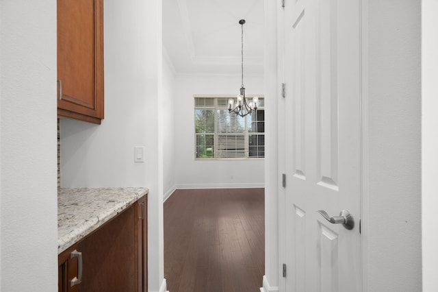 18006 SW Cosenza Way, Port Saint Lucie, FL 34987 - kitchen with crown molding, a chandelier, dark wood-style floors, hanging light fixtures, and baseboards