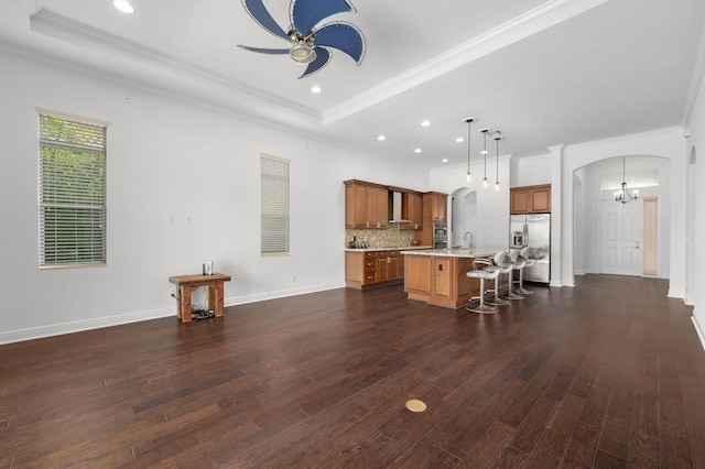 18006 SW Cosenza Way, Port Saint Lucie, FL 34987 - living area with arched walkways, a ceiling fan, crown molding, dark wood-style flooring, and a chandelier