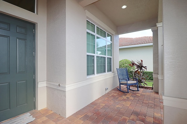 18006 SW Cosenza Way, Port Saint Lucie, FL 34987 - property entrance featuring stucco siding and a porch