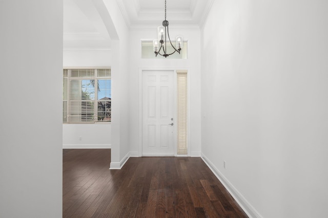 18006 SW Cosenza Way, Port Saint Lucie, FL 34987 - foyer with a chandelier, dark wood-style floors, arched walkways, baseboards, and crown molding