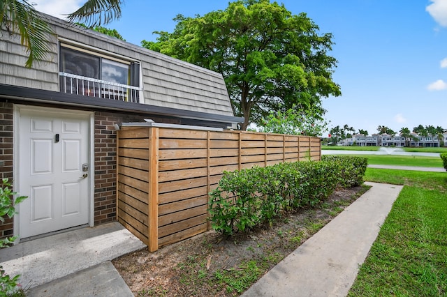 1508 15th Ter, Palm Beach Gardens, FL 33418 - doorway to property with brick siding and mansard roof