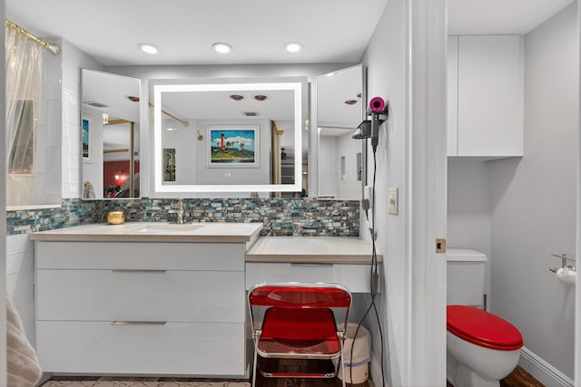 1508 15th Ter, Palm Beach Gardens, FL 33418 - bathroom featuring vanity and tasteful backsplash
