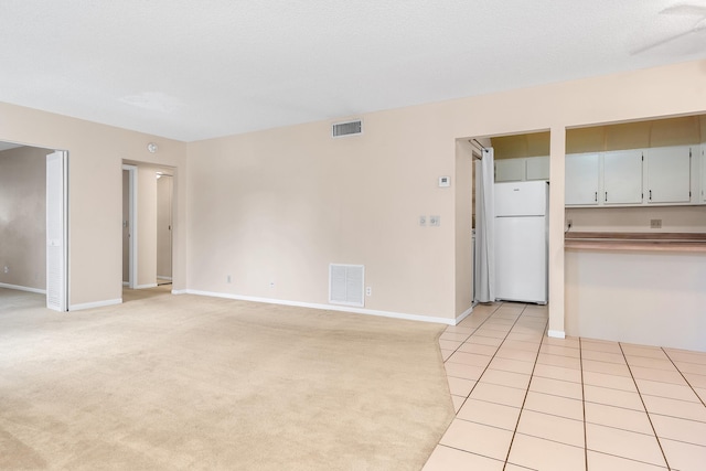 531 Shady Pine Way Unit A 2, Greenacres, FL 33415 - unfurnished living room with baseboards, light carpet, and light tile patterned floors