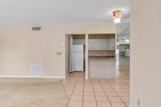 531 Shady Pine Way Unit A 2, Greenacres, FL 33415 - kitchen with freestanding refrigerator, a ceiling fan, a textured ceiling, baseboards, and light tile patterned floors