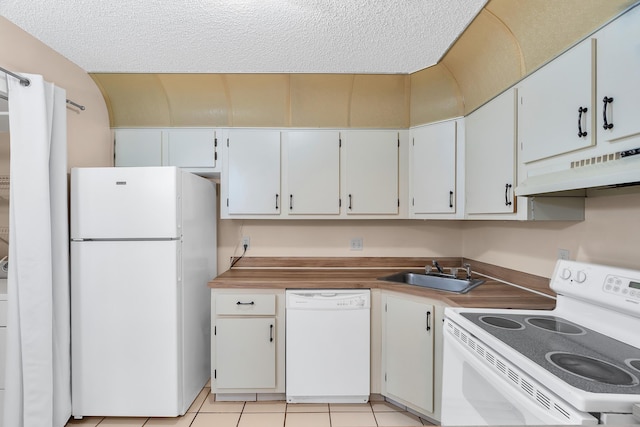 531 Shady Pine Way Unit A 2, Greenacres, FL 33415 - kitchen with white appliances, under cabinet range hood, a sink, a textured ceiling, and light tile patterned flooring