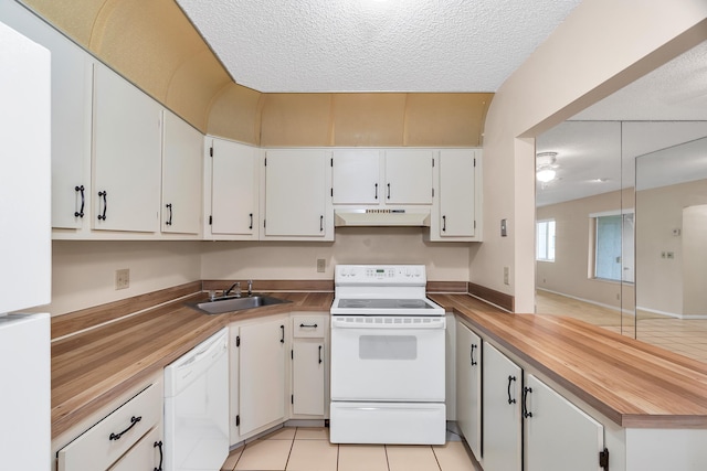 531 Shady Pine Way Unit A 2, Greenacres, FL 33415 - kitchen with white appliances, under cabinet range hood, a peninsula, a sink, and white cabinets