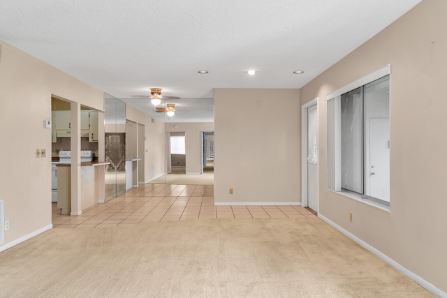 531 Shady Pine Way Unit A 2, Greenacres, FL 33415 - unfurnished living room featuring light carpet, light tile patterned flooring, ceiling fan, baseboards, and recessed lighting