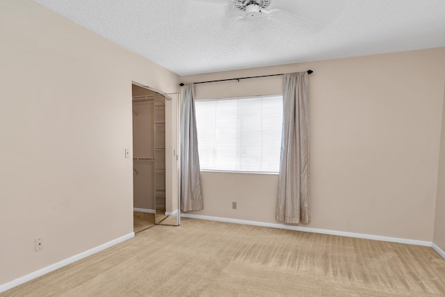 531 Shady Pine Way Unit A 2, Greenacres, FL 33415 - empty room with a ceiling fan, carpet, a textured ceiling, and baseboards