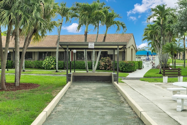 531 Shady Pine Way Unit A 2, Greenacres, FL 33415 - view of front of house with a front yard, a shingled roof, and stucco siding