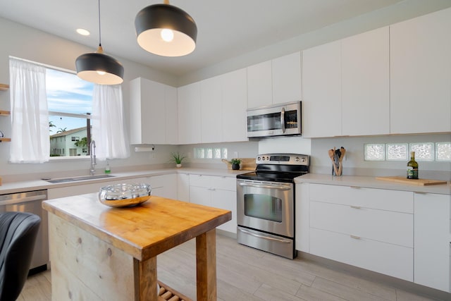 1026 Center Stone Ln, Riviera Beach, FL 33404 - kitchen with appliances with stainless steel finishes, plenty of natural light, light countertops, light wood-style floors, and recessed lighting