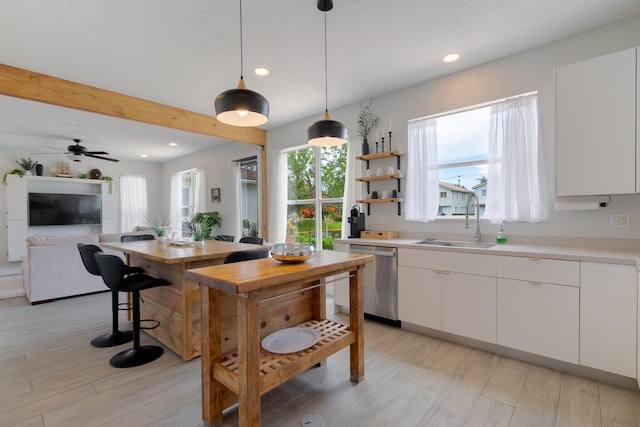 1026 Center Stone Ln, Riviera Beach, FL 33404 - kitchen with dishwasher, recessed lighting, light countertops, and white cabinetry