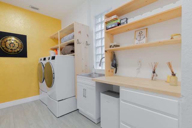 1026 Center Stone Ln, Riviera Beach, FL 33404 - laundry area with separate washer and dryer, cabinet space, and a textured wall