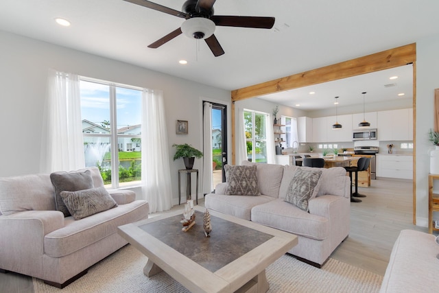 1026 Center Stone Ln, Riviera Beach, FL 33404 - living room featuring recessed lighting, ceiling fan, beamed ceiling, and light wood-style flooring