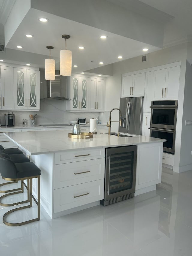 701 S Olive Ave Unit 819, West Palm Beach, FL 33401 - kitchen featuring wine cooler, appliances with stainless steel finishes, recessed lighting, white cabinets, and decorative backsplash
