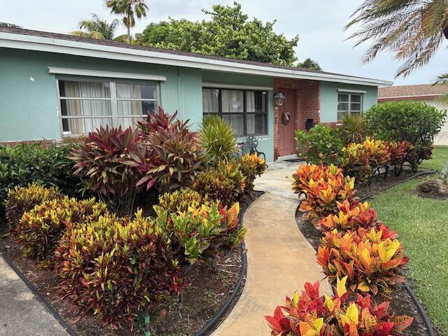729 W Kalmia Dr, Lake Park, FL 33403 - view of front facade with stucco siding