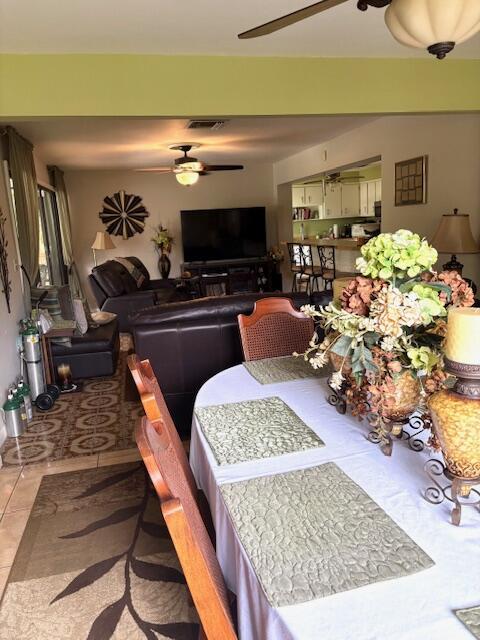 729 W Kalmia Dr, Lake Park, FL 33403 - tiled dining space featuring ceiling fan
