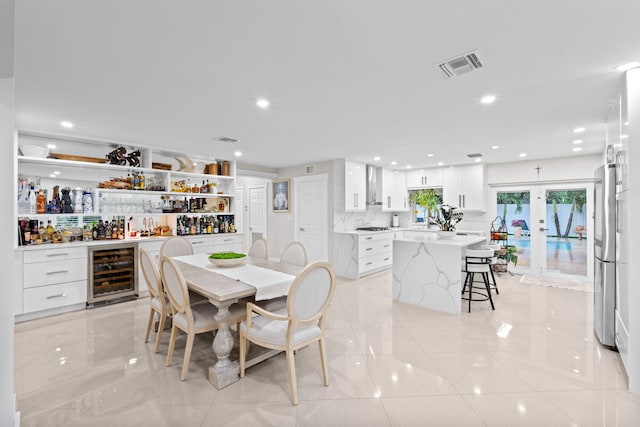 936 Upland Rd, West Palm Beach, FL 33401 - dining area featuring wine cooler, a bar, recessed lighting, and french doors
