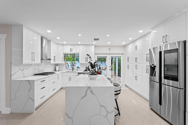 936 Upland Rd, West Palm Beach, FL 33401 - kitchen with appliances with stainless steel finishes, modern cabinets, wall chimney range hood, a sink, and recessed lighting