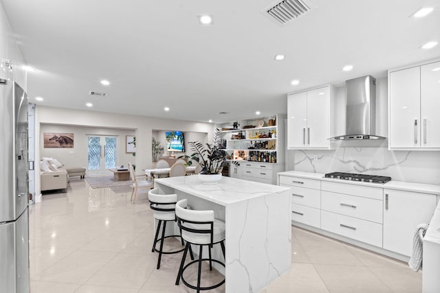 936 Upland Rd, West Palm Beach, FL 33401 - kitchen featuring wall chimney range hood, appliances with stainless steel finishes, modern cabinets, light tile patterned flooring, and recessed lighting