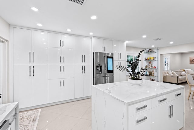 936 Upland Rd, West Palm Beach, FL 33401 - kitchen featuring stainless steel refrigerator with ice dispenser, light stone counters, modern cabinets, white cabinets, and recessed lighting
