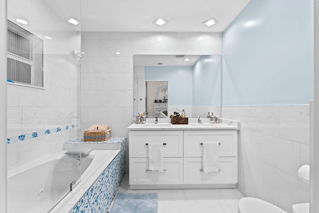 936 Upland Rd, West Palm Beach, FL 33401 - full bath featuring tile walls, a whirlpool tub, double vanity, tile patterned floors, and toilet