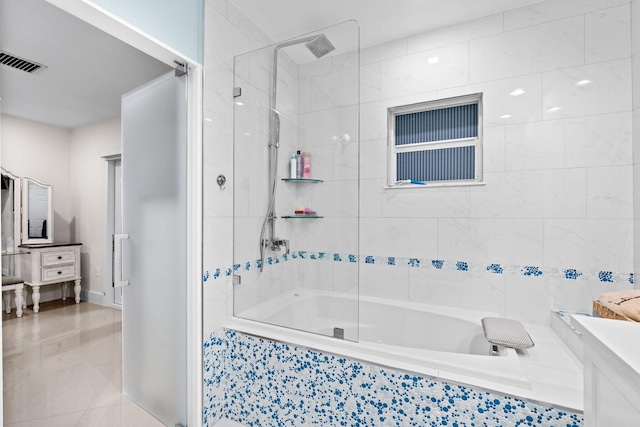 936 Upland Rd, West Palm Beach, FL 33401 - bathroom featuring vanity, tiled shower / bath, tile patterned floors, and baseboards