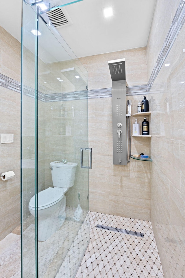 936 Upland Rd, West Palm Beach, FL 33401 - full bath featuring toilet, a stall shower, tile walls, and tile patterned floors