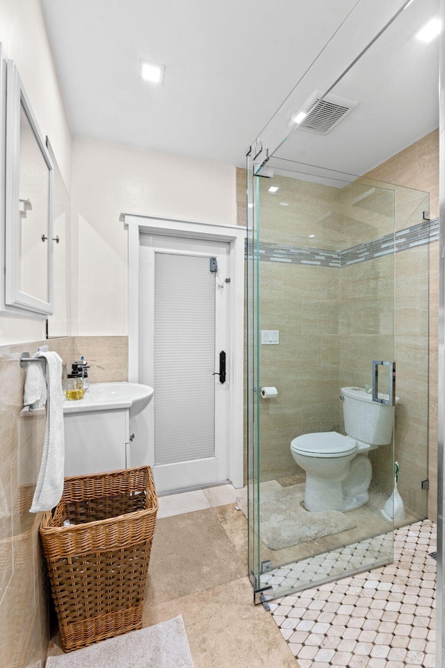 936 Upland Rd, West Palm Beach, FL 33401 - full bath featuring vanity, a shower stall, toilet, and tile walls
