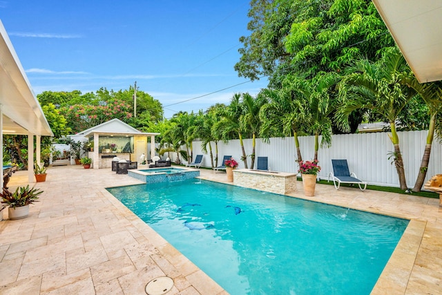 936 Upland Rd, West Palm Beach, FL 33401 - view of swimming pool with a gazebo, a patio area, a fenced backyard, and a pool with connected hot tub