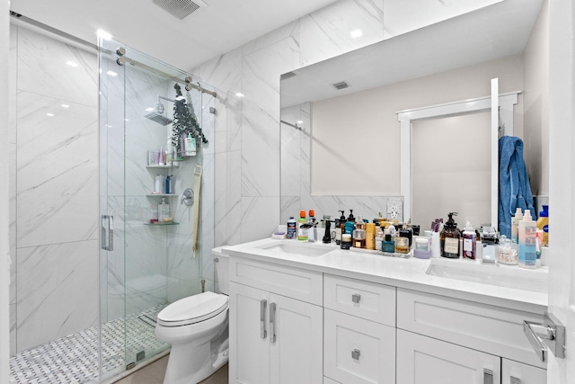936 Upland Rd, West Palm Beach, FL 33401 - bathroom featuring double vanity, a marble finish shower, toilet, and tile walls