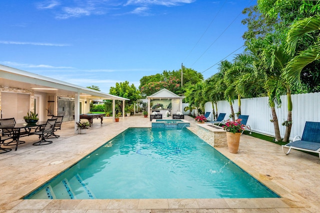 936 Upland Rd, West Palm Beach, FL 33401 - view of swimming pool with a gazebo, a patio, a fenced backyard, an outdoor bar, and a pool with connected hot tub