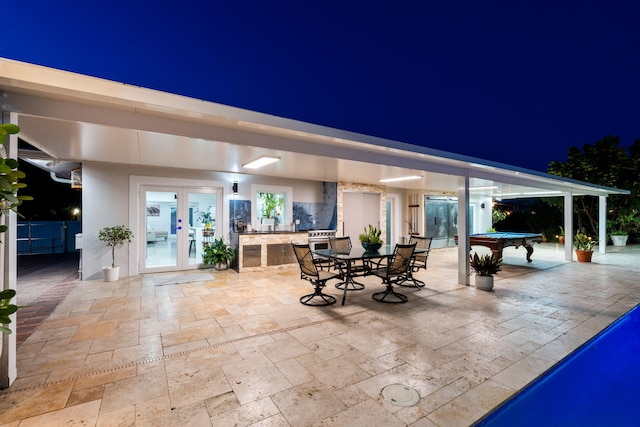 936 Upland Rd, West Palm Beach, FL 33401 - patio at twilight featuring a patio area, french doors, and outdoor dining area