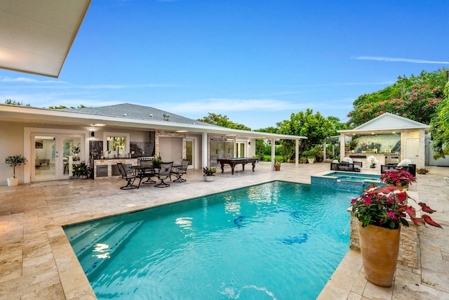 936 Upland Rd, West Palm Beach, FL 33401 - view of swimming pool featuring french doors, a patio, and a pool with connected hot tub