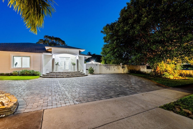936 Upland Rd, West Palm Beach, FL 33401 - view of front of house featuring decorative driveway and french doors