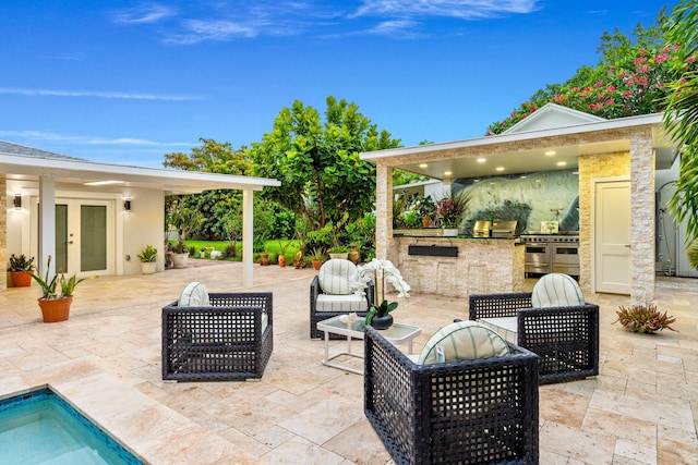 936 Upland Rd, West Palm Beach, FL 33401 - view of patio / terrace with exterior kitchen and french doors